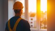 © Panida - Construction Worker Looking at Sunset from Window in Empty Room with Warm Light and Open Space Atmosphere