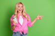 © deagreez - Cheerful lovelyWoman With Smartphone Pointing Excitedly on Green Background