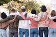 © Prostock-studio - Back view of international group of people in casual outfits hugging on the street, unrecognizable multiracial students standing in a row and embracing outdoors, panorama