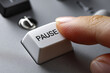 © CozyDigital - A man presses the Pause white button with his finger. Close-up of the finger and the button.