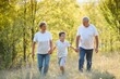 © Serhii - Grandparents walking with they grandson in summer sunset