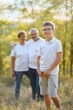© Serhii - Grandfather grandmother and grandson having fun outdoors in park
