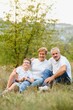 © Serhii - Grandparents and grandson together in autumn park
