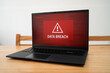 © Kevin - Urgent data breach notification on corporate laptop. Concept of being hacked and cyber crime.
