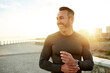 © MollerFinest/peopleimages.com - Runner, fitness and happy man in city in morning for exercise, marathon training or cardio workout. Sports, lens flare and person for wellness, rest and laugh for performance, endurance and running