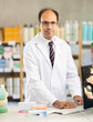 © JackF - Adult male pharmacist working with computer in pharmacy
