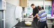 © peopleimages.com - Volunteer, charity and community with a man working in the kitchen of a learning and development center. Healthcare, wellness and activism with a male social worker teaching and coaching a patient