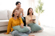 © NT_studio - Group young asian friends watching TV together in a cozy living room at home with happy, laughing and enjoying sitting on sofa for watching television with relax, lifestyle and entertainment.