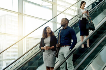 Poster - People, escalator and talking in office building for business, new day or coworkers. Employees, corporate team or stairs in company with meeting schedule, discussion or planning productivity