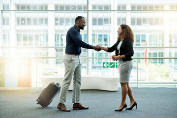 Poster - Handshake, luggage and welcome with business people in airport lobby for friendly greeting or meeting. B2B, smile or travel with employee man and woman shaking hands for international partnership