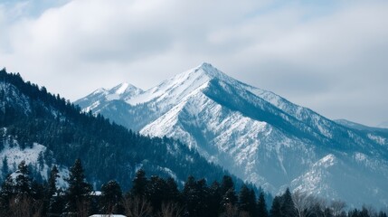 Aufkleber - Snow-capped mountain peak towers above the rugged terrain with a clear view of the surrounding range under a crisp sky perfect for outdoor activities and branding