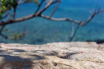 Fototapete - Summer copy space with blue sky and sea blurred backdrop. Tropical summer vacation product placement podium. Stone empty template with leaves shadows and soft sunlight summer cozy warm mock up.