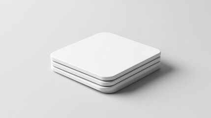 Aufkleber - Three white square objects stacked on a light gray surface.
