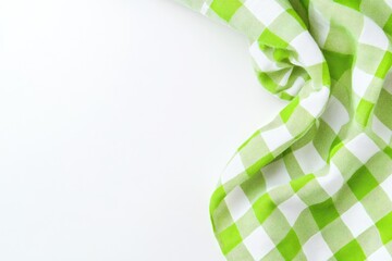 Leinwandbilder - Green and white checkered cloth napkin draped on white surface  Folded and arranged in a corner, creating a visual design element