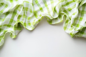 Leinwandbilder - Green and white checkered fabric draped on a white surface  Folded fabric with a soft texture, showing a pattern of squares in vibrant green and white