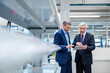 © Westend61 - Business executives discussing strategy in a production hall using a tablet