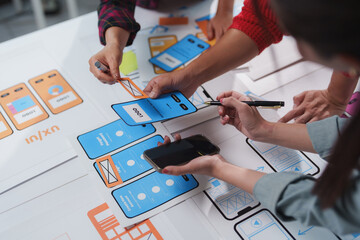 Wall Mural - web designers are collaborating on user interface and user experience design for a mobile applicatio