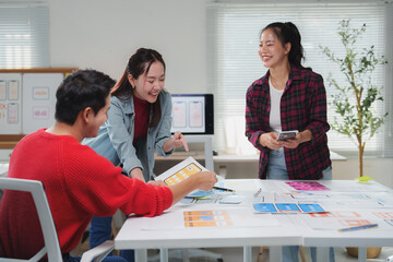 Wall Mural - diverse group of young professionals engaging in a brainstorming session for a mobile app design. th