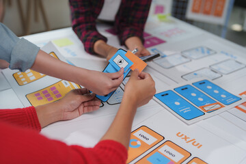 Wall Mural - web designers are working together to develop user interface and user experience by adding paper pro