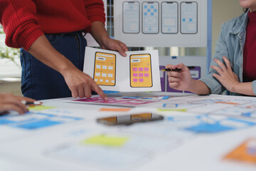 Wall Mural - web designers are developing an app for mobile phones, choosing the right color palette from a set o