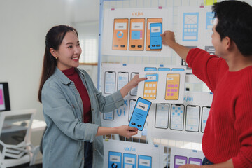 Wall Mural - design team brainstorming in a modern office, focusing on mobile app interface development. two coll
