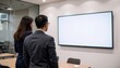 © Nattapol - Business meeting with professionals viewing a screen display.