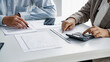 © mojo_cp - Startup business people teamwork calculating a valuation in workplace