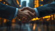 © Thanthara - close up of handshake symbolizing business agreement in modern urban setting