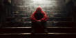 © Inspire Shots Hub - Person in red hoodie sits on dark stone steps, head bowed, conveying loneliness and despair, symbolizing hardship or isolation