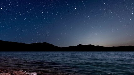 Wall Mural - a a movement of stars in the night sky with the view of mountains.