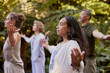 © Rido - Group in meditation praying together with outstretched arms