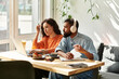© LIGHTFIELD STUDIOS - Couple collaborates on remote freelance projects in stylish cafe setting