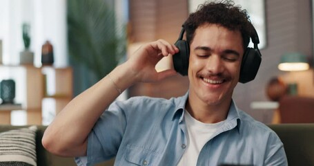Aufkleber - Headphones, dancing and man with smartphone on sofa in home for chatting, relaxing and listen to music. Audio tech, phone and person with networking and streaming album on mobile app in living room.