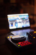 © Elias - A large aperture closeup of a DJ deck / soundboard / setup and software on laptop screen with blurred background