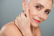 © deagreez - Charming mature woman with white hair and natural makeup revealing radiant confident beauty on grey soft background