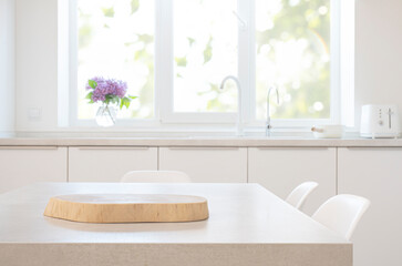 Wall Mural - smooth wooden pedestal for product on grey table in blurred daylight kitchen interior