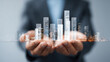 © sri - Business growth hands hold bar graph