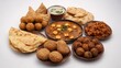 © PerfectPhotos - Here's a collection of popular Indian foods seen from above. It includes paneer curry, samosas, kofta, omelet, chole bhature, garlic naan, chole, and fried rolls.