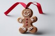 © Abda - A gingerbread man cookie ornament with a red ribbon, isolated on a white background, symbolizing festive holiday decoration.