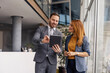 © Dusan Petkovic - Businessman standing with his female colleague at enterprise and scrolling on tablet.