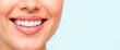© Anastasiya - Smiling woman showcasing perfect teeth against a light background