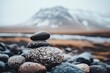 © ani - Stacked stones against a mountain backdrop