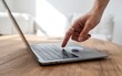 © mojebor - Finger On Laptop Touchpad Security And Technology In A Bright Modern Home Office For Secure Access And Login Authentication