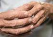 © yongyut - Close up of hands of an old man, shallow depth of field