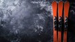 © Kumblack - Overhead shot of vibrant orange skis against a textured dark backgroun