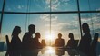 © theo - Silhouette of business team in meeting at sunset with city views in office