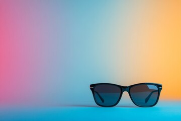 Poster - A classic pair of black sunglasses rests on a flat surface, featuring a stylish minimalist design against a soft pastel background with ample copy space