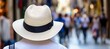 © Ilja - Woman in Straw Hat Walks Busy City Street, Back View, Summer Tourism, Urban Exploring