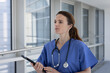 © ReeldealHD images - Female Doctor in Scrubs Holding Tablet