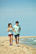 © Dialogue Frame - Young Couple Running on the Beach